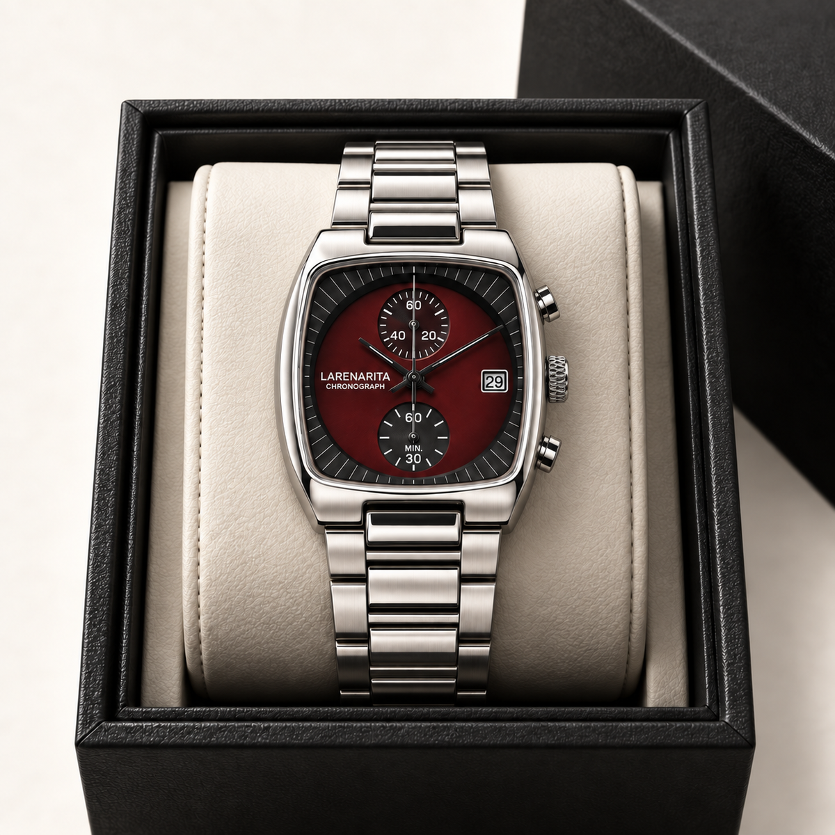 Claret Red Langford watch styled on an ivory cushion in a black presentation case