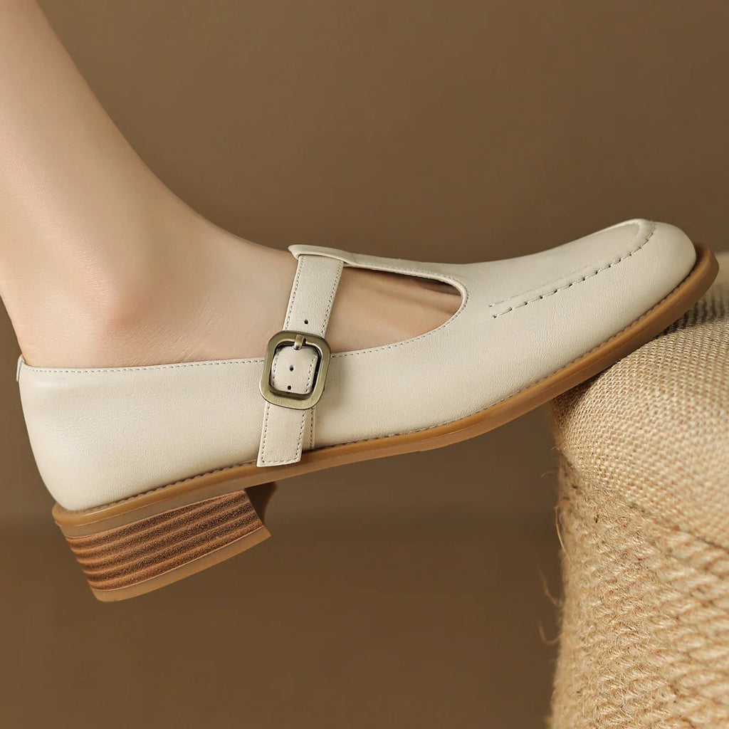 White shoe with brown sole and buckle on a blurred background