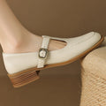 White shoe with brown sole and buckle on a blurred background