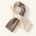 Alden two-tone wool scarf in Taupe & Ivory, styled in its pull-through shape on warm cream