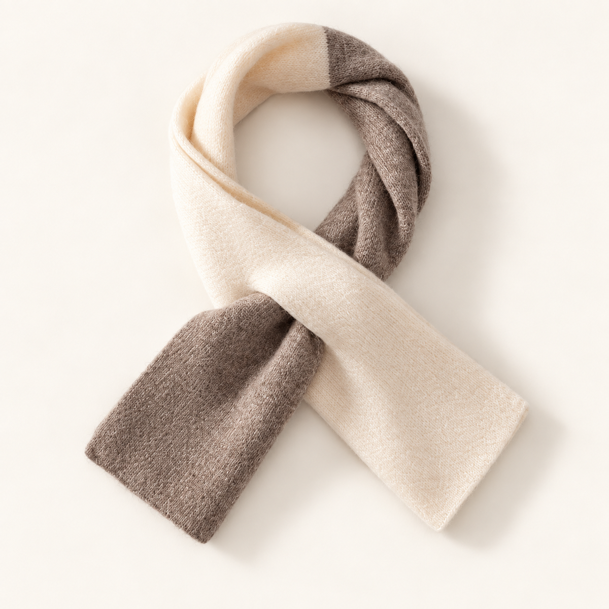 Alden two-tone wool scarf in Taupe & Ivory, styled in its pull-through shape on warm cream