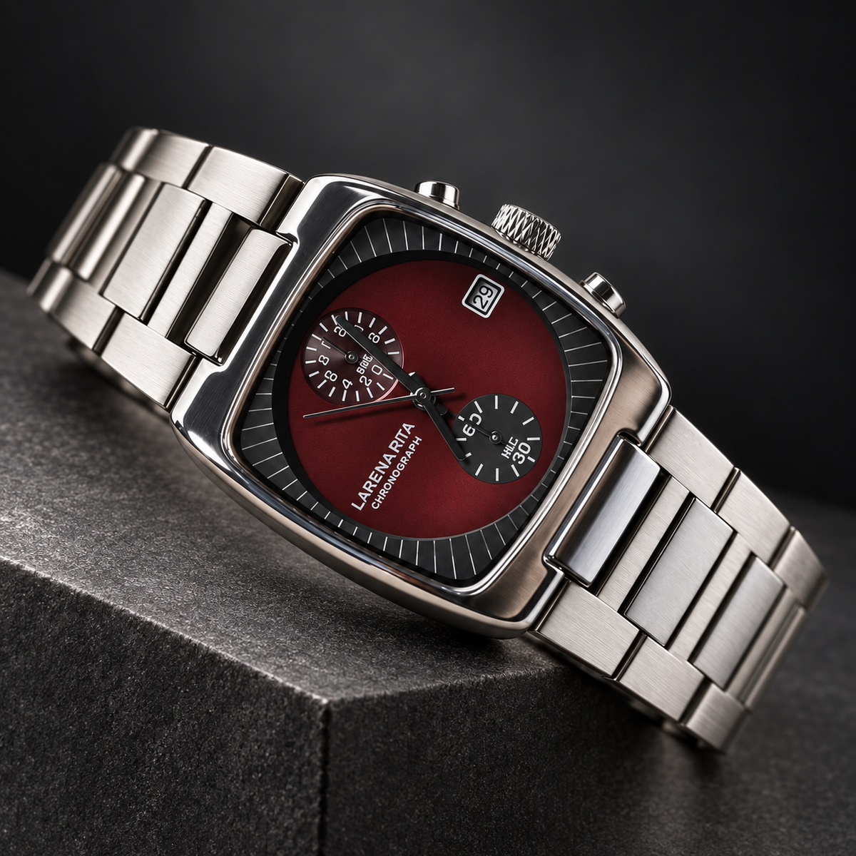 Claret Red square chronograph watch on graphite stone with sculpted studio lighting